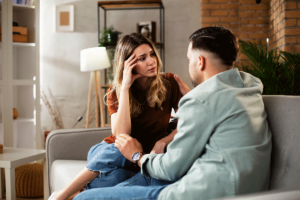man and a woman having a serious discussion in their home about the importance of addressing codependency in Relationships