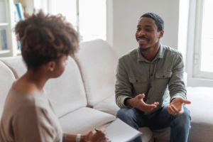 A man discusses setting goals in therapy with his therapist.