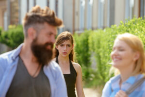 A girl is watching her parents' enabling behavior.